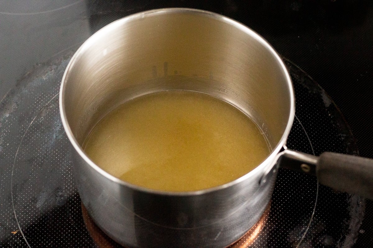 a medium saucepan with lemon juice and sugar in it on a stovetop
