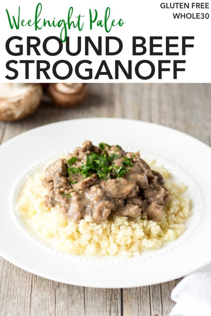 pin for whole30 ground beef stroganoff showing a white plate with cauliflower rice topped with ground beef stroganoff and some chopped parsley on it.