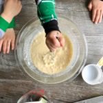 little kids whisking pancake mix in a bowl