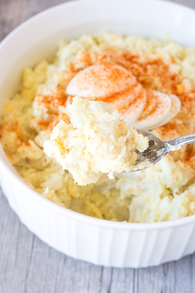 spoon digging gluten free instant pot potato salad out of a white bowl