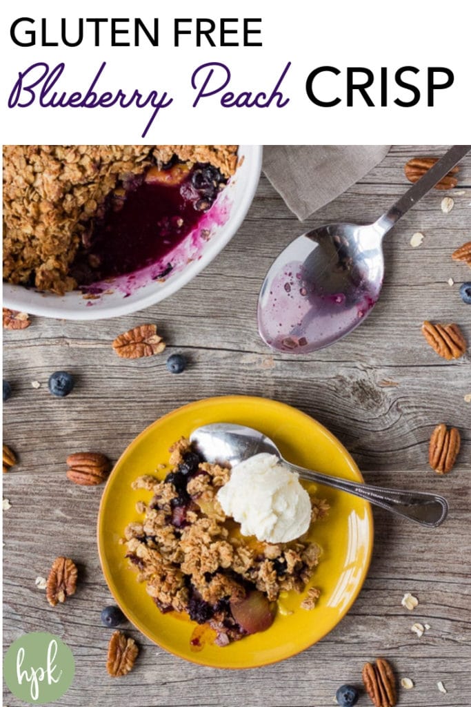 This Gluten Free Blueberry Peach Crisp is naturally sweetened with maple syrup and no other sugar. It's a simple dessert recipe that is so easy to make even your kids can help. The topping has gluten free oats and crunchy pecans, giving the dish a warm, nutty flavor. Try it for the last taste of summer! #glutenfree #dessert #peach #crisp #blueberry #recipe