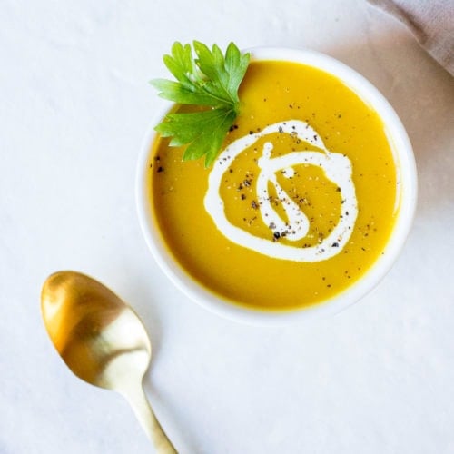 slow cooker curried butternut squash soup in a bowl with a gold spoon
