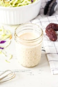 healthy paleo coleslaw dressing in a jar with slaw accompaniments