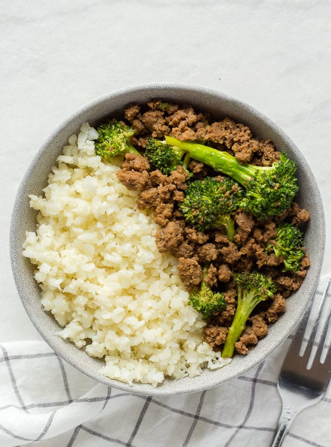 top down shot of paleo beef and broccoli stir fry in a gray bowl