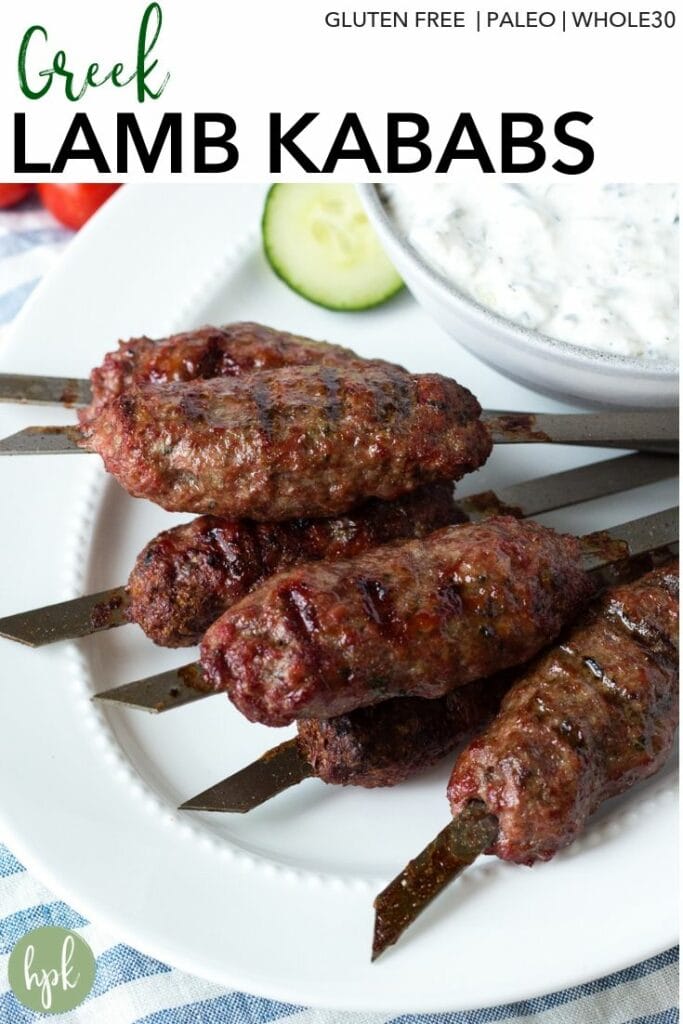 Pinterest image for Greek Lamb Kabobs with black text at the top and an image of ground lamb kabobs on a white platter.
