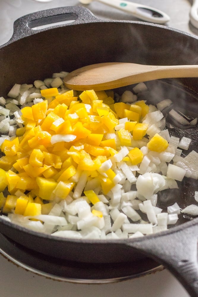 diced onion and yellow bell pepper in a skillet