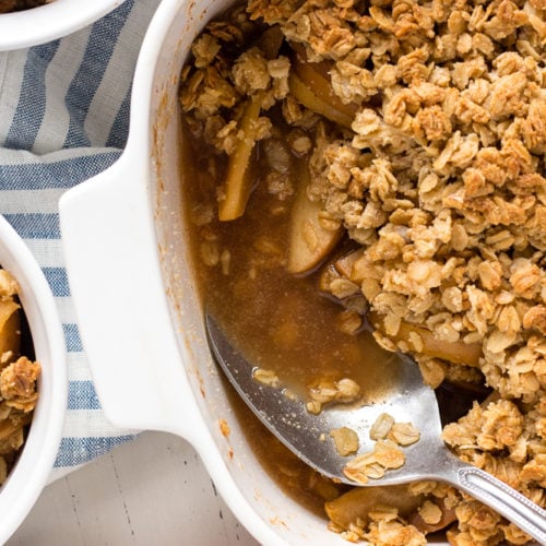 apple crisp in a dish with a spoon