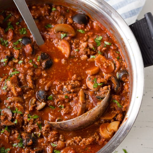 meat sauce in a pot with a ladle
