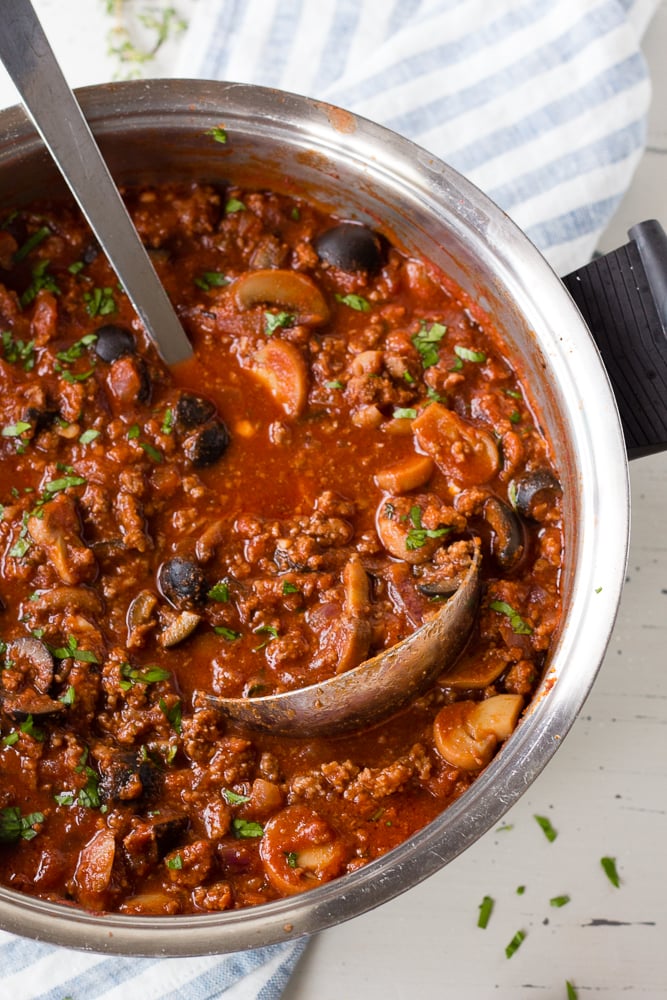 meat sauce in a pot with a ladle