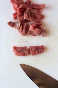 cutting strips of beef