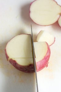 dicing potatoes on a cutting board