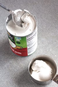 scooping coconut cream out of a can