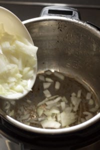 pouring cut onions into instant pot