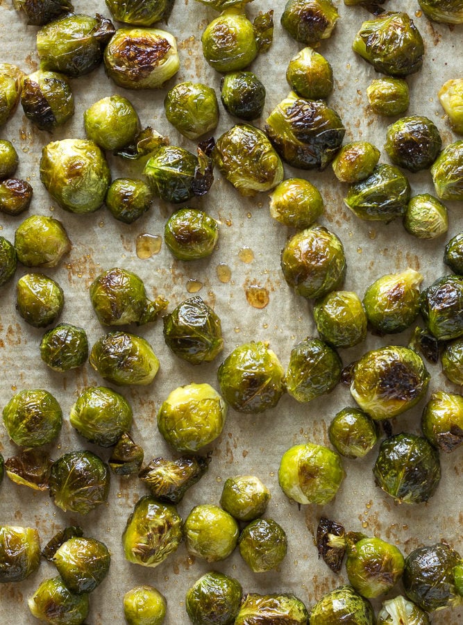 cooked maple roasted brussels sprouts on a sheet pan