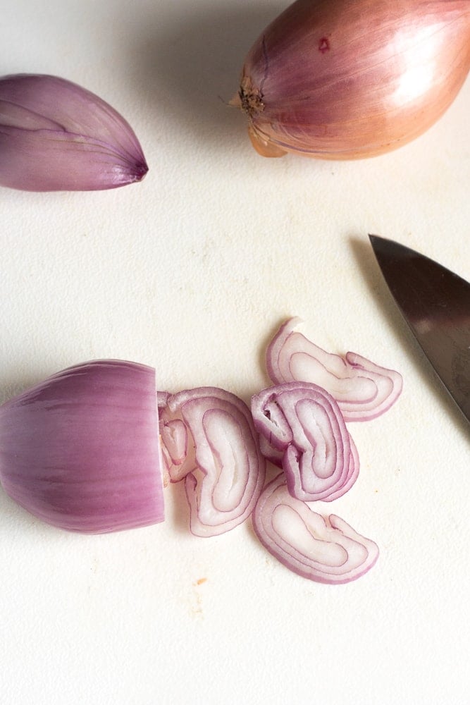 sliced shallots of a cutting board