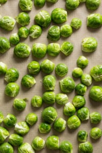 cut brussels sprouts on a sheet pan