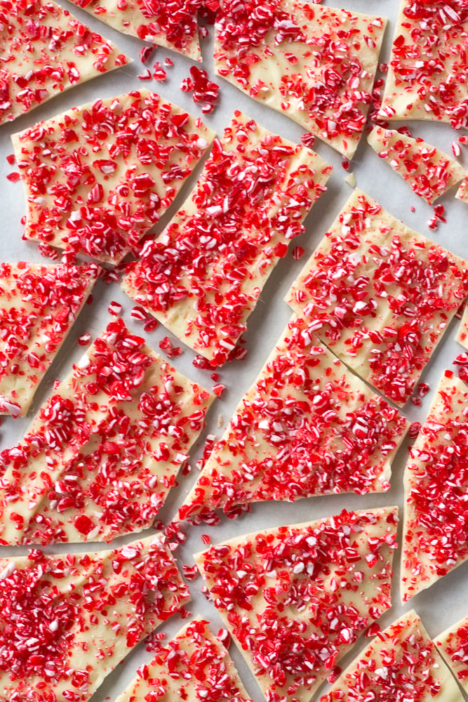 Broken pieces of white chocolate sprinkled with red and white peppermint candy bits.