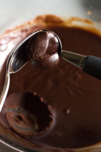 scooping out chocolate truffle mixture with a spoon