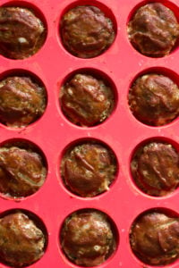 cooked paleo meatloaf muffins in red silicone pan