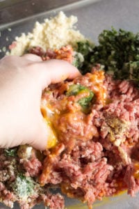 mixing paleo meatloaf muffin ingredients by hand