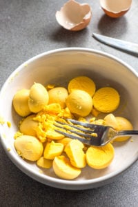 egg yolks in a bowl with a fork
