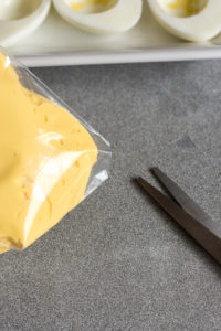 cutting tip of plastic bag for deviled egg mixture