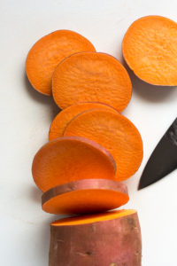 slicing a sweet potato