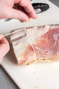 tying kitchen twine on a pork roast