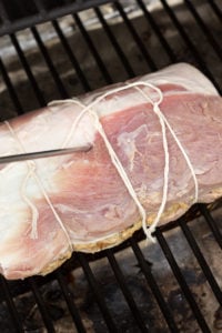 a temperature probe going into a pork roast