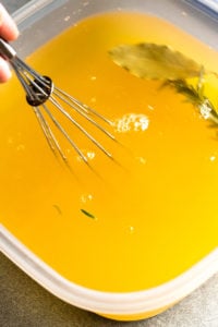 stirring salt into a brine solution with a whisk
