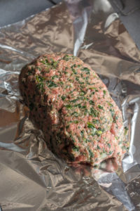uncooked meatloaf on foil