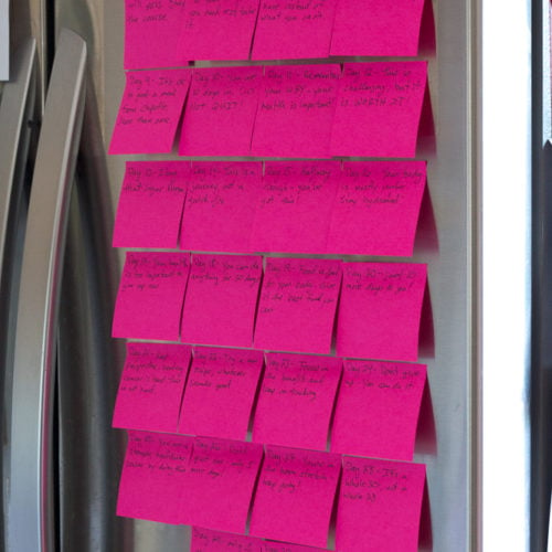 pink post it notes on a silver fridge