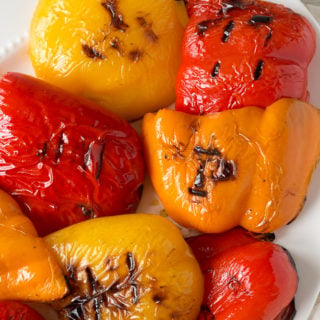 grilled bell peppers on a white platter