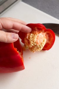 taking the top off a red bell pepper
