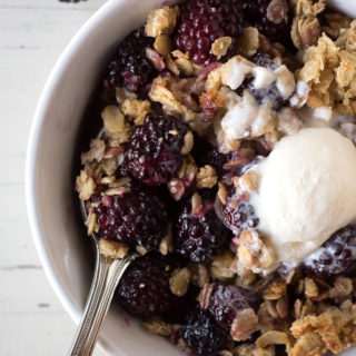 blackberry crisp in a bowl with a spoon