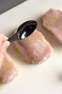 pouring oil on pork chops