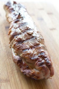 pork tenderloin resting on a cutting board