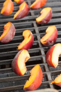 sliced peaches on a grill