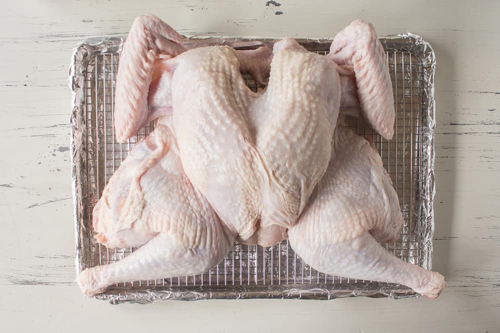 a dry brined spatchcocked turkey on a sheet pan