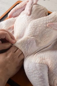 separating the skin from the meat of a raw turkey