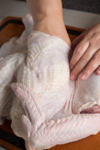 separating the skin from the breast of a raw turkey