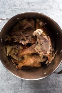 a large pot with a turkey carcass in it