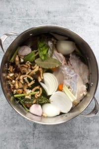 a large pot with ingredients for turkey stock in it.