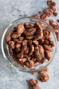glazed pecans in a small glass bowl