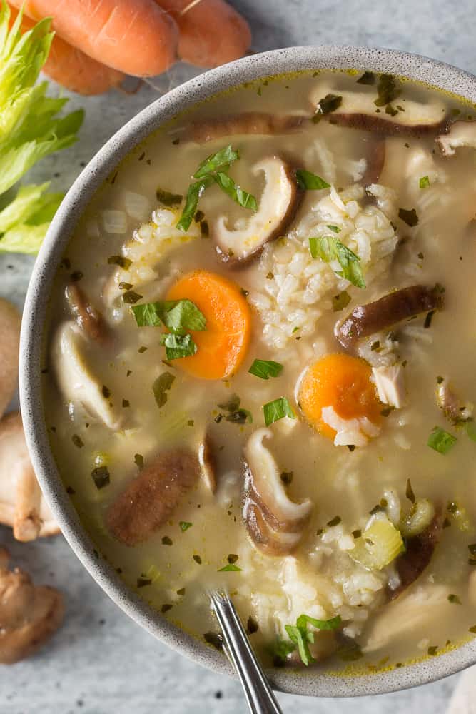 a bowl of turkey rice soup with a spoon in it