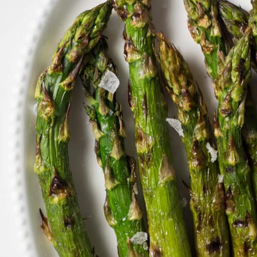 easy grilled asparagus on a white platter