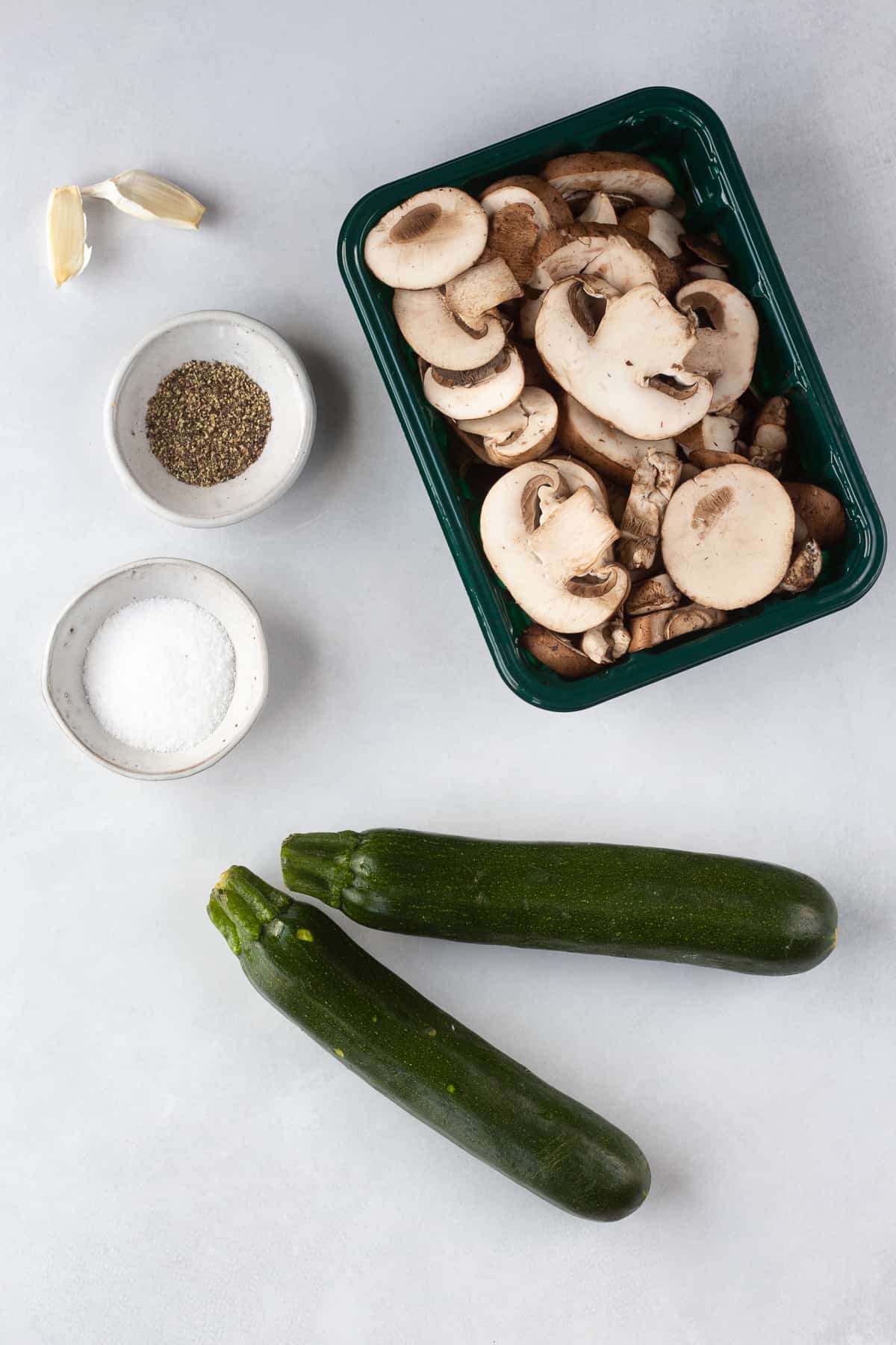 Top down shot of ingredients for sauteed zucchini and mushrooms