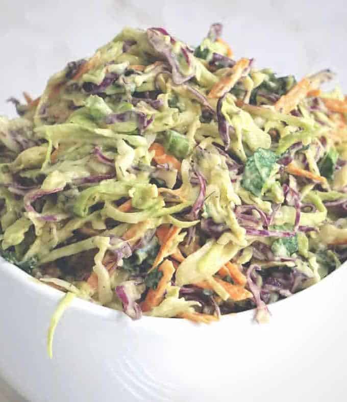 Close up of a coleslaw made without mayo in a small white bowl.