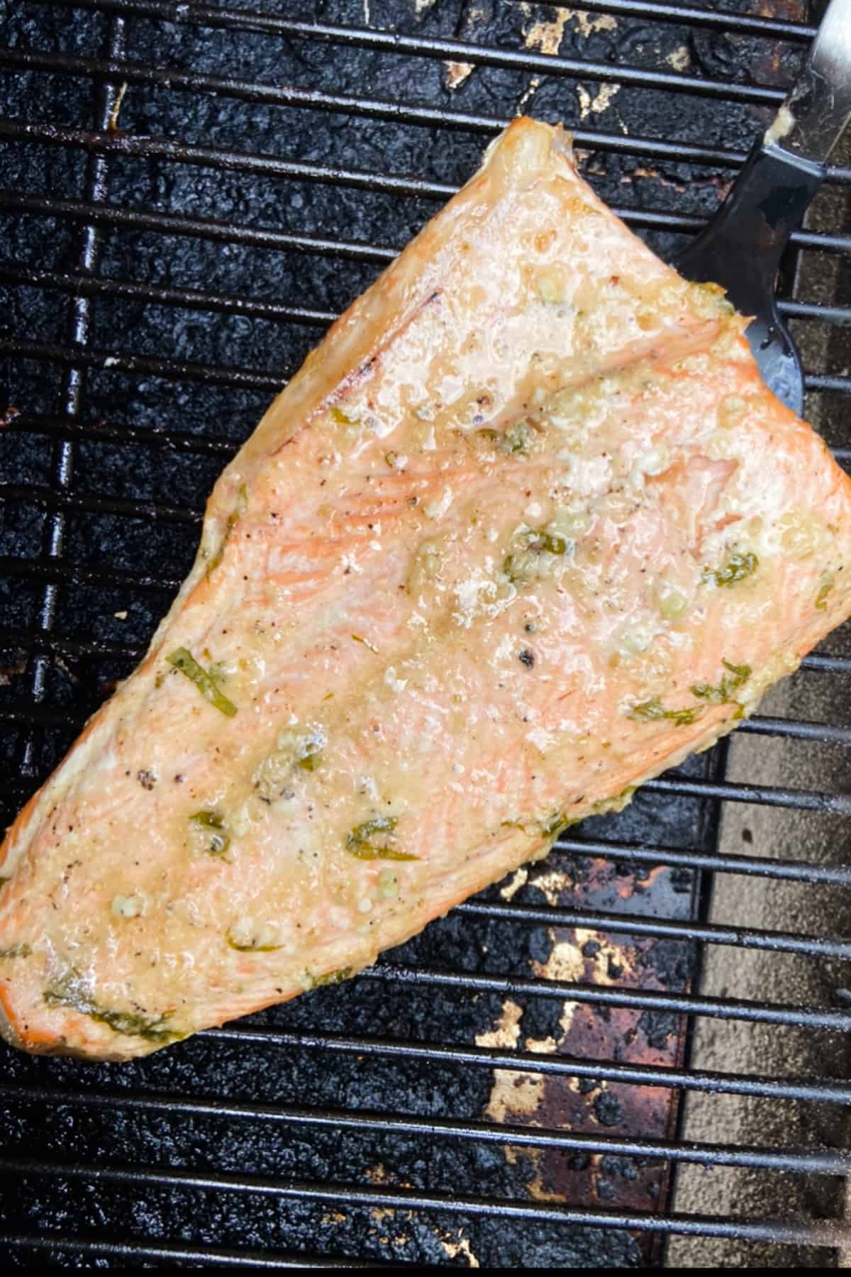 Top down close up of a large fillet of grilled fish on the grill.