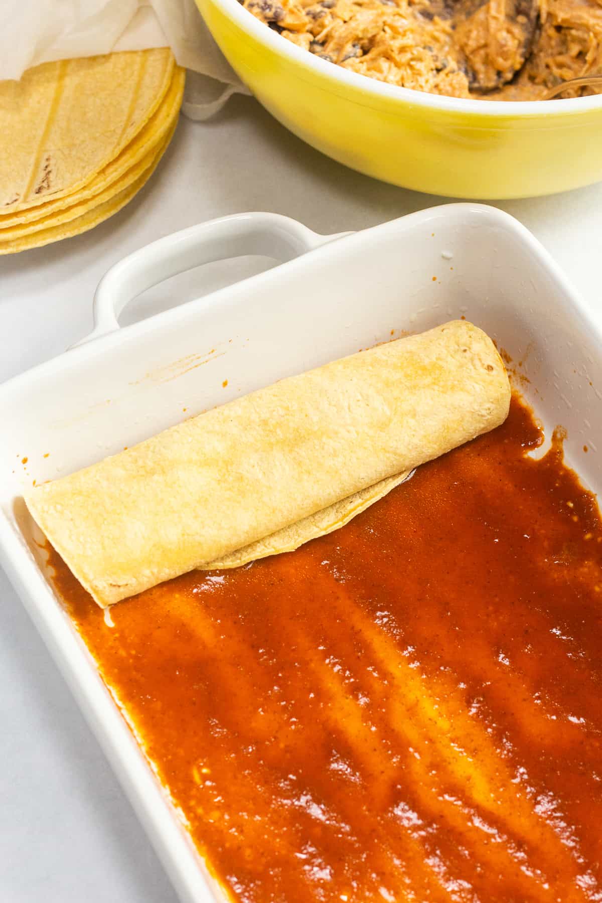A rolled up uncooked enchilada